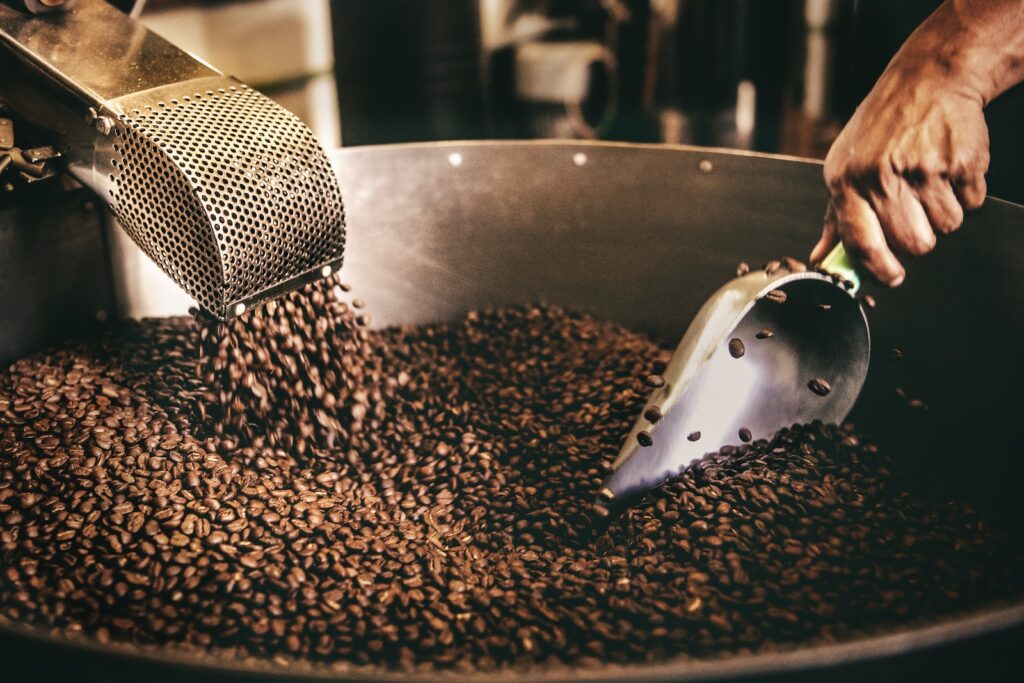 black and white ceramic fish figurine on black and brown coffee beans