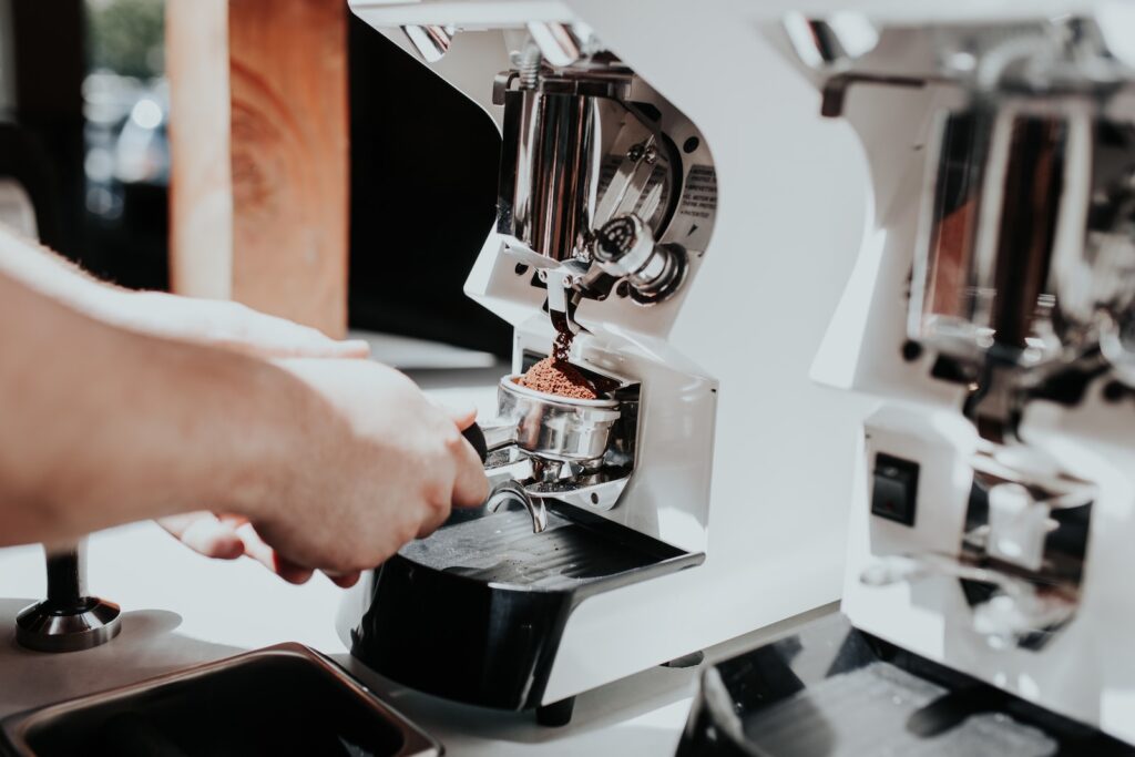 person using espresso inside kitchen